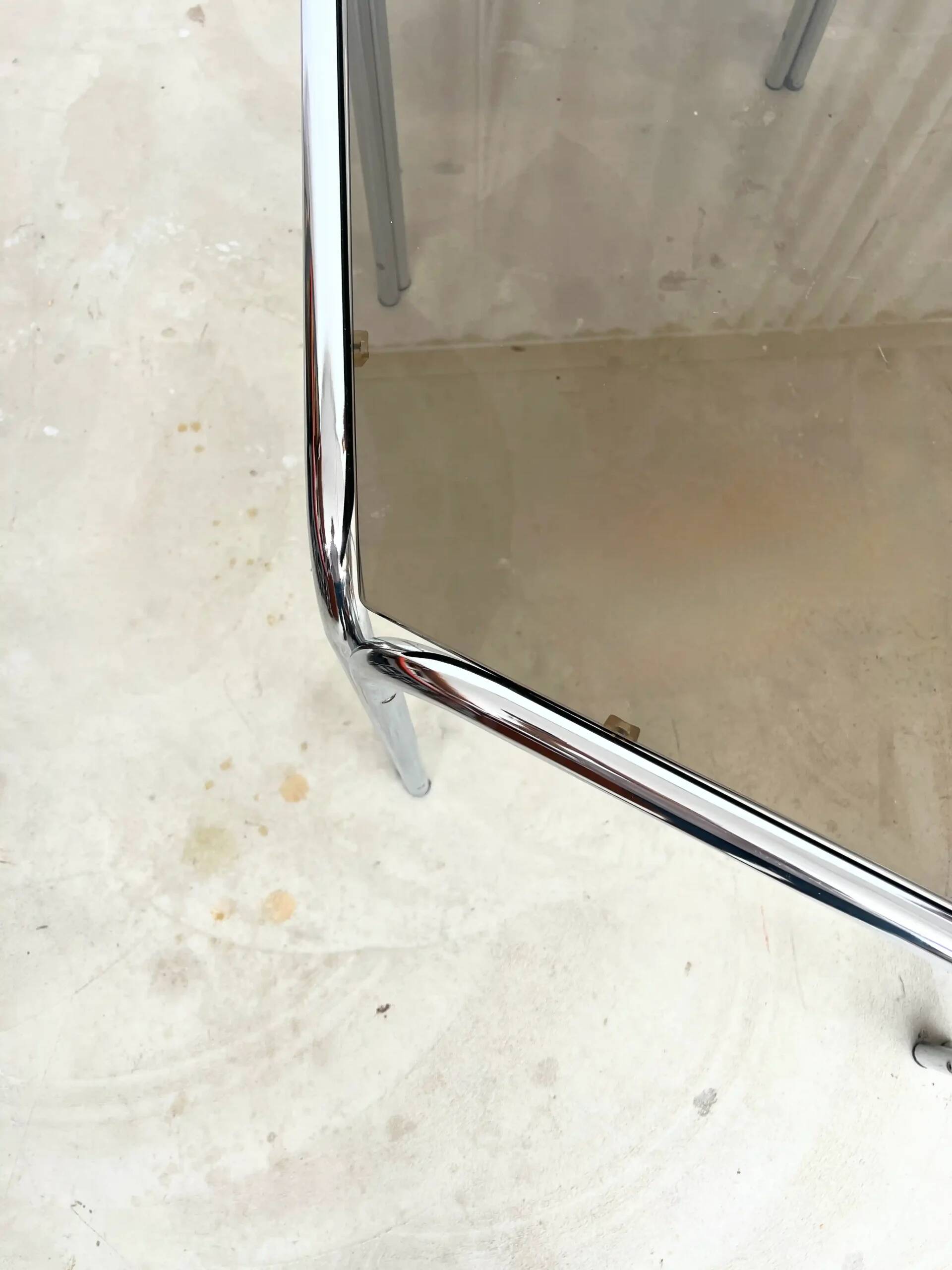 Vintage hexagonal table with smoked glass top and chrome metal structure.