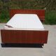 Vintage bed in teak with integrated bedside table.