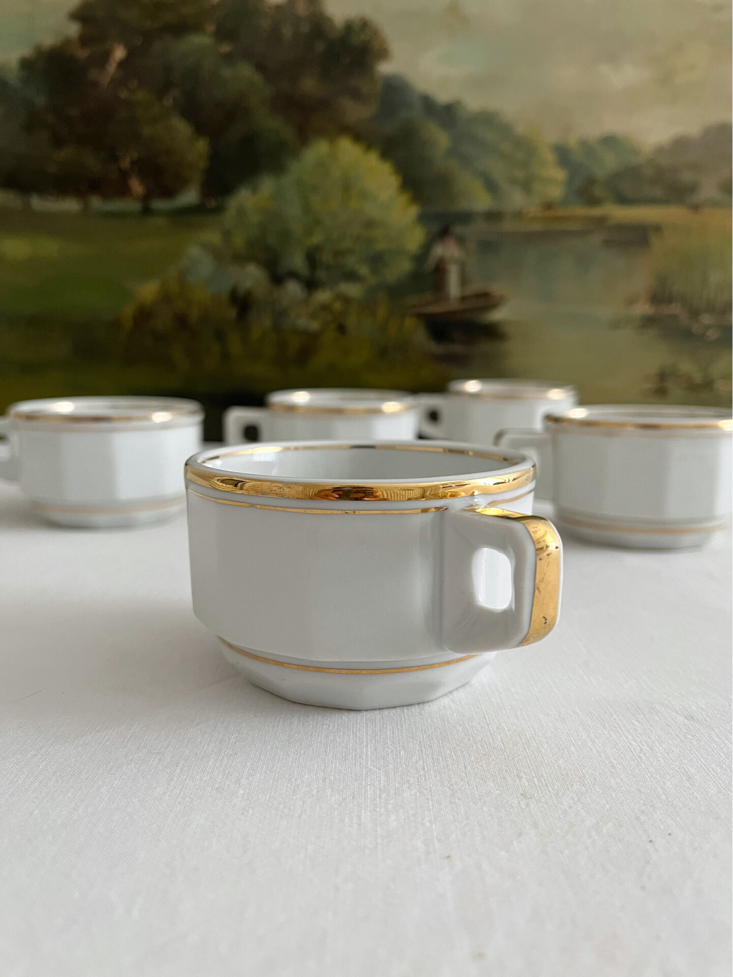 5 vintage porcelain bistro coffee cups from Paris with gold trim.