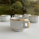 5 vintage porcelain bistro coffee cups from Paris with gold trim.