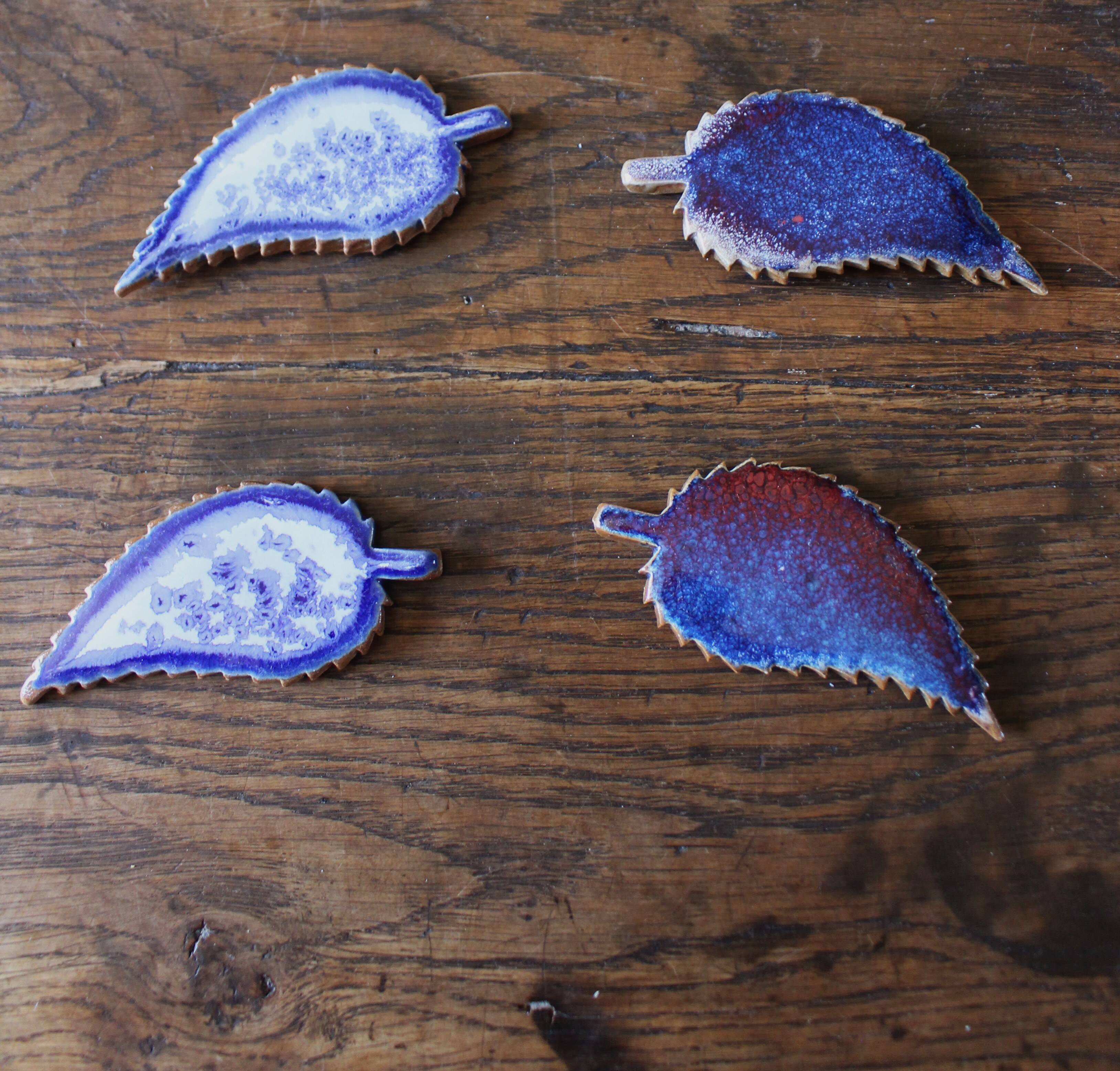 A set of 4 handcrafted pottery knife rests in blue.