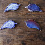 A set of 4 handcrafted pottery knife rests in blue.
