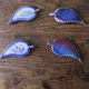 A set of 4 handcrafted pottery knife rests in blue.