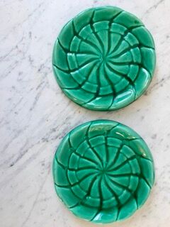 Duo of green slip bottle coasters signed marjac bauzil 50s