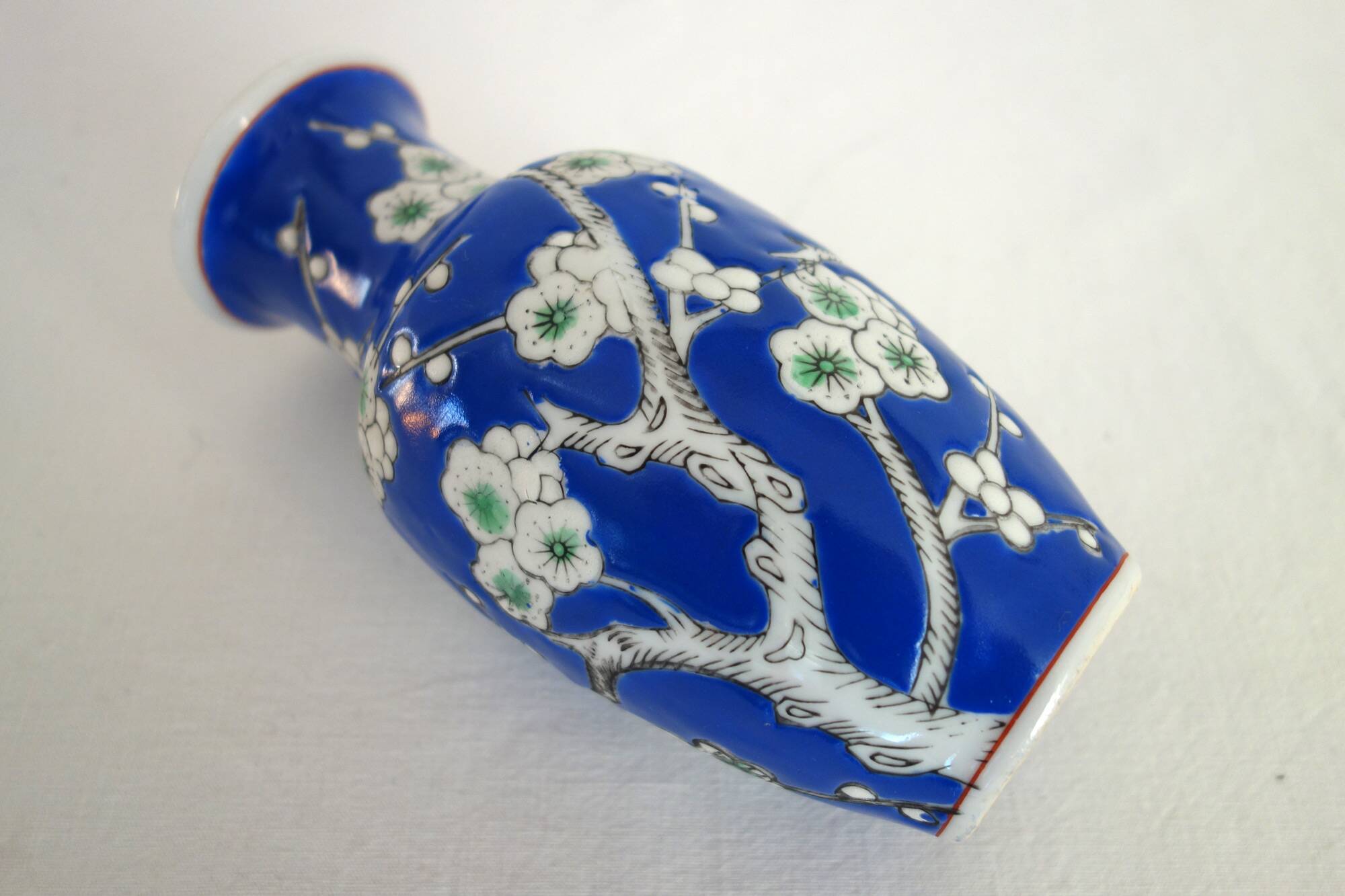 Old blue vase with vintage porcelain cherry blossoms