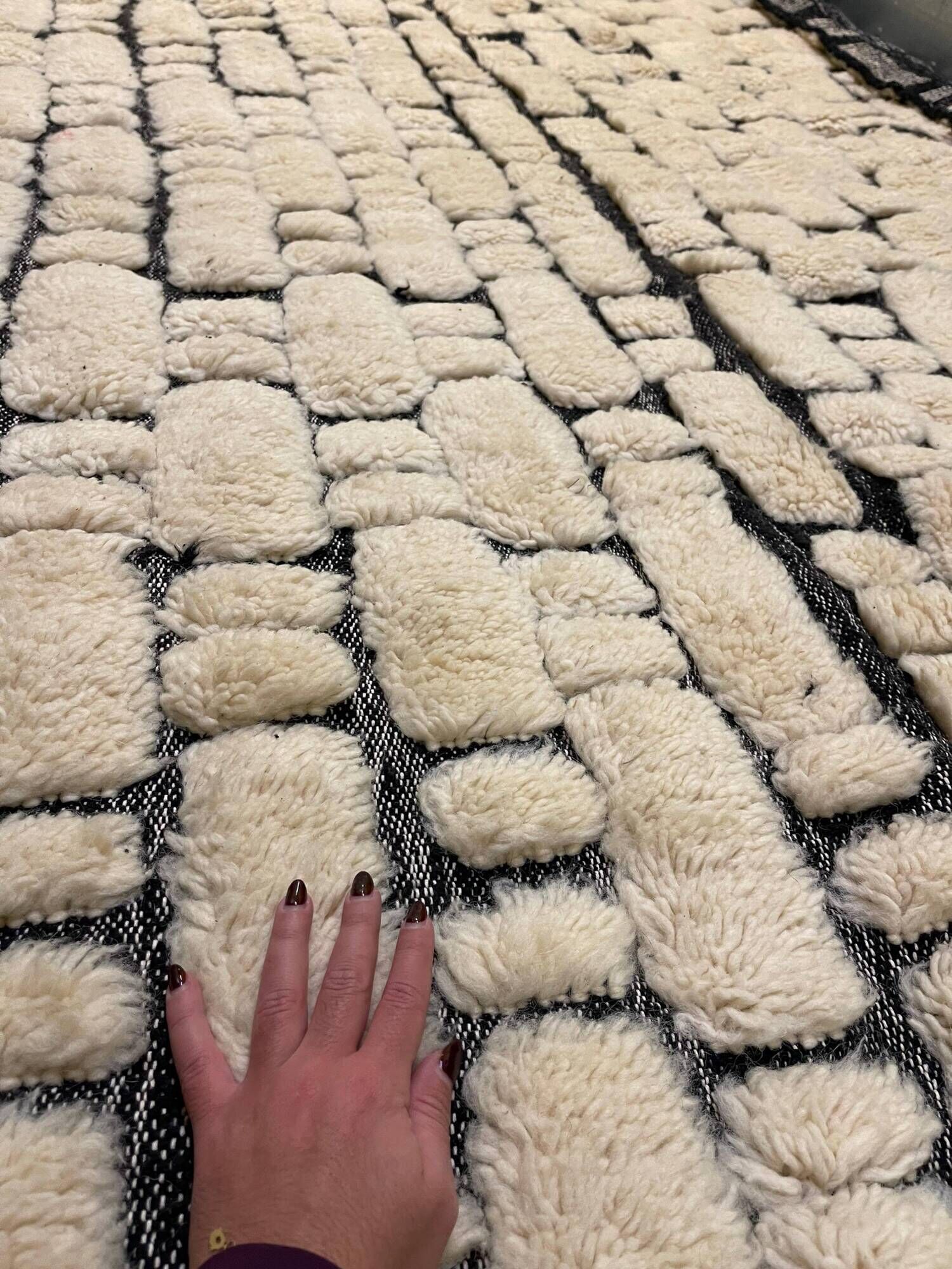 Large cream and black checked Berber rug, 280 × 200 cm.
