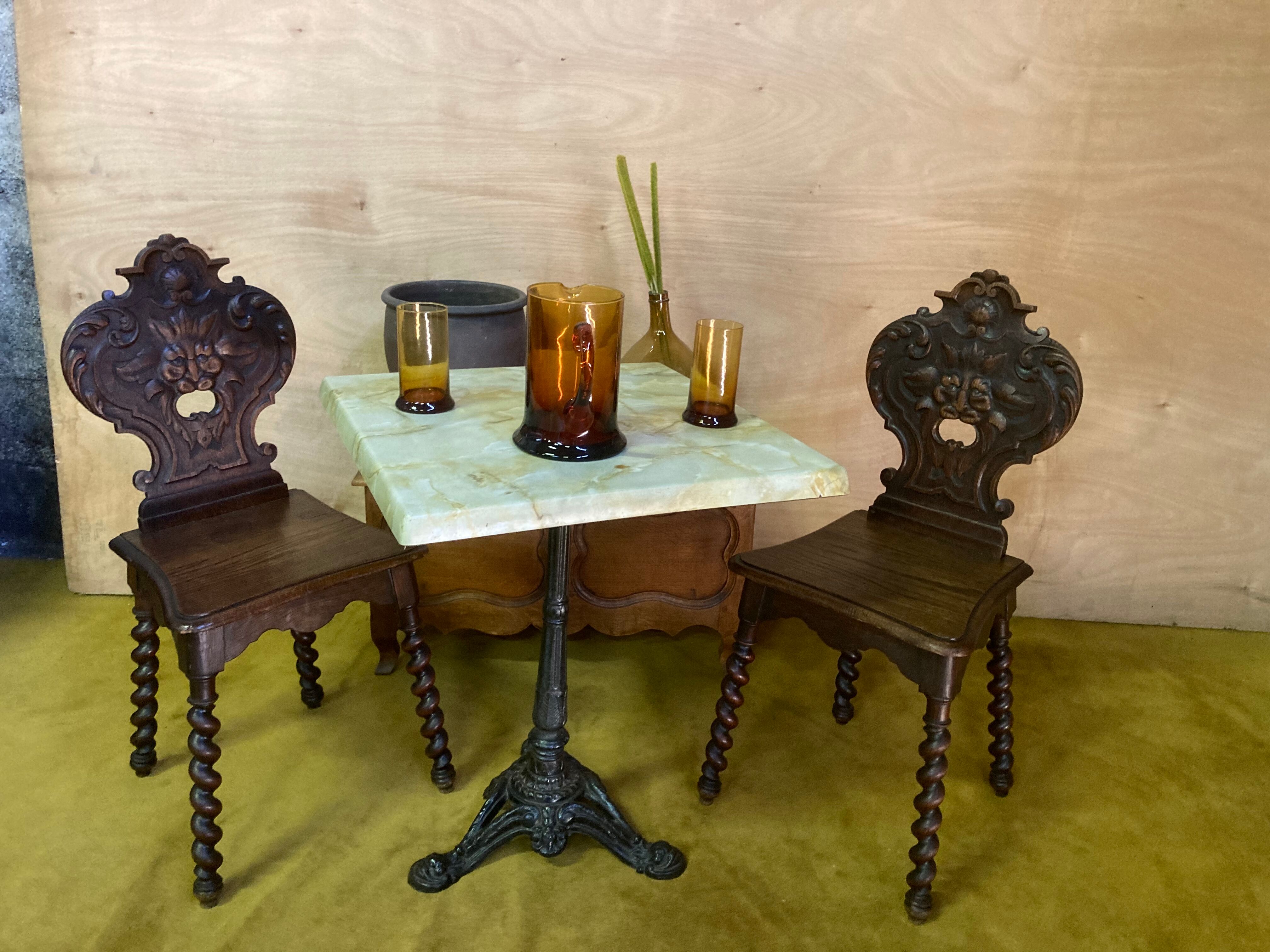 Duo of carved wooden chairs