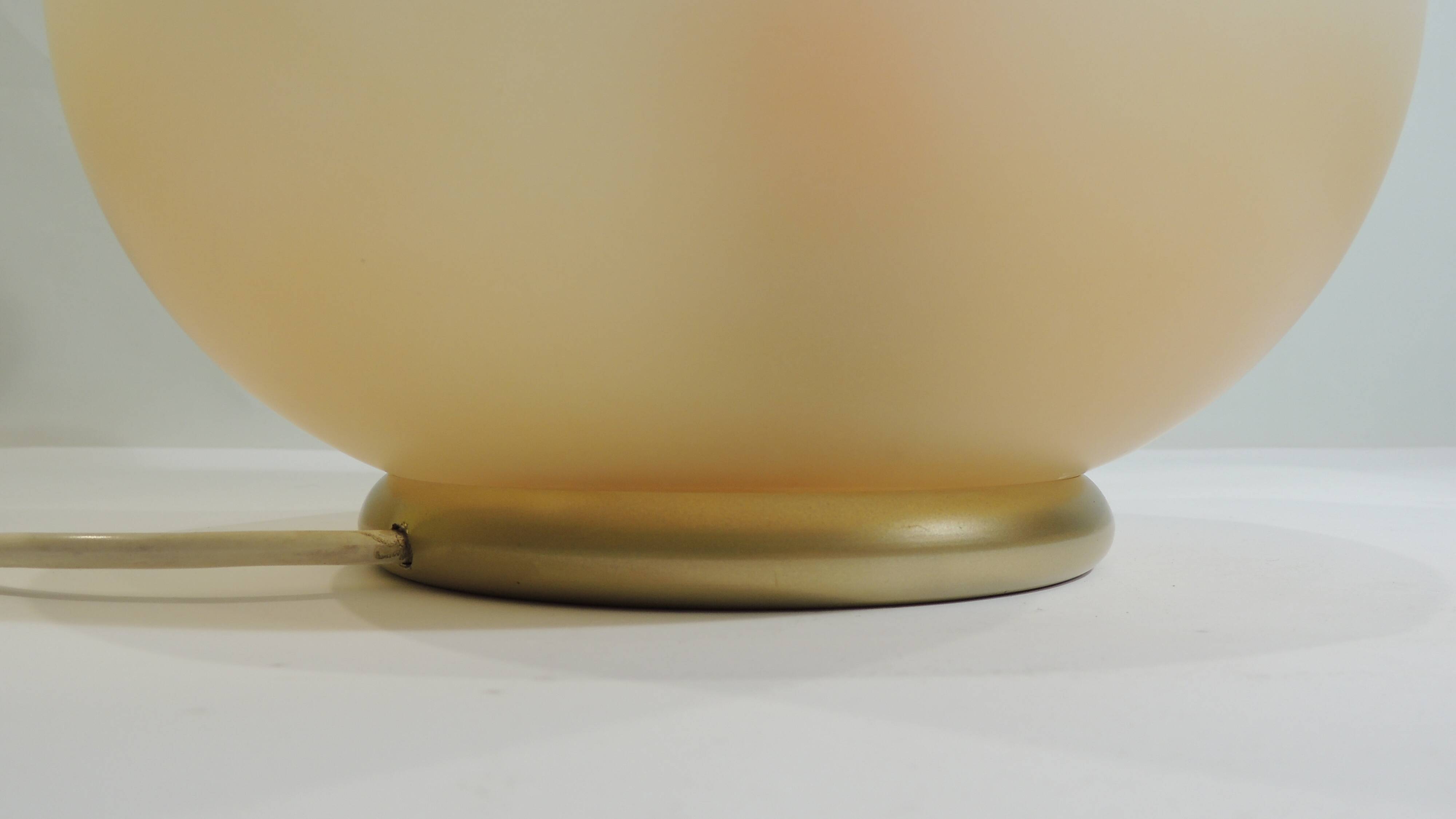 Vintage frosted glass lamp, round globe, elegant design, soft light.