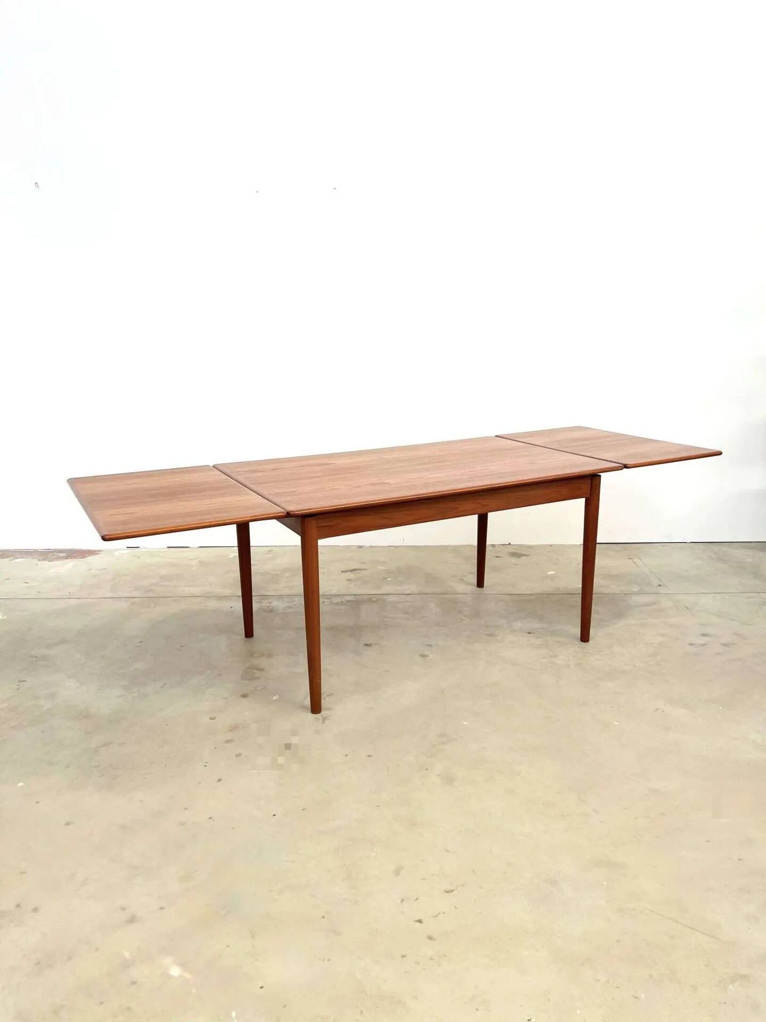 Teak dining table with integrated extensions — Scandinavian