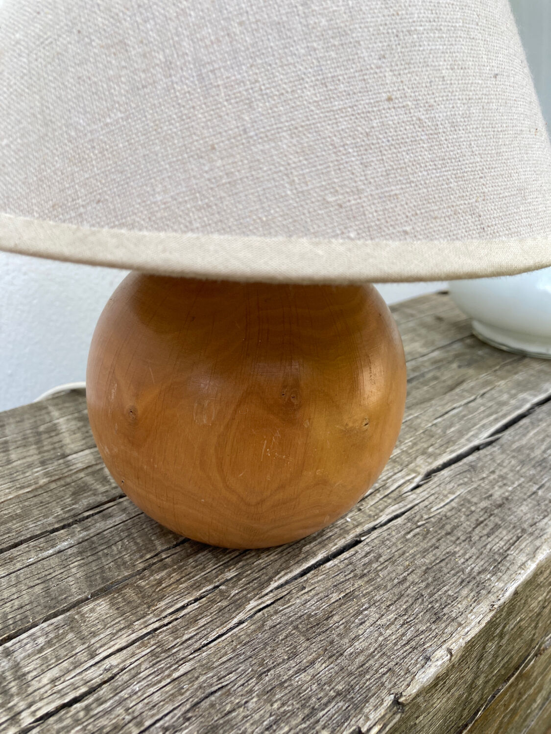 Wooden ball bedside lamp and beige lampshade