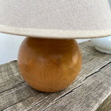 Wooden ball bedside lamp and beige lampshade