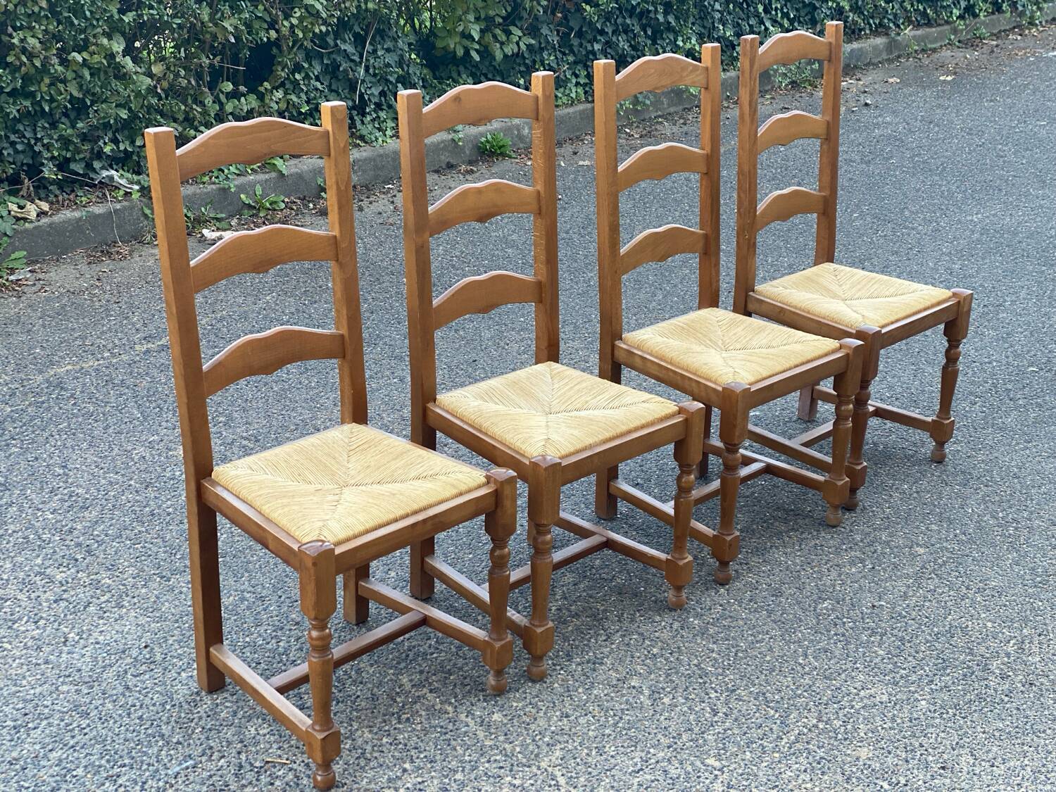 4 straw and solid wood chairs with high backs