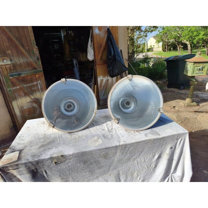 Pair of industrial pendant lights in aluminium and glass.