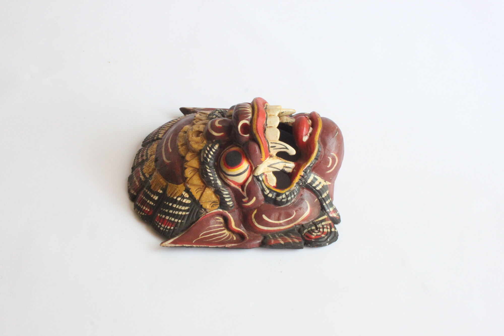 Two polychrome painted and gold leaf gilded Barong dance masks from Bali, Indonesia.
