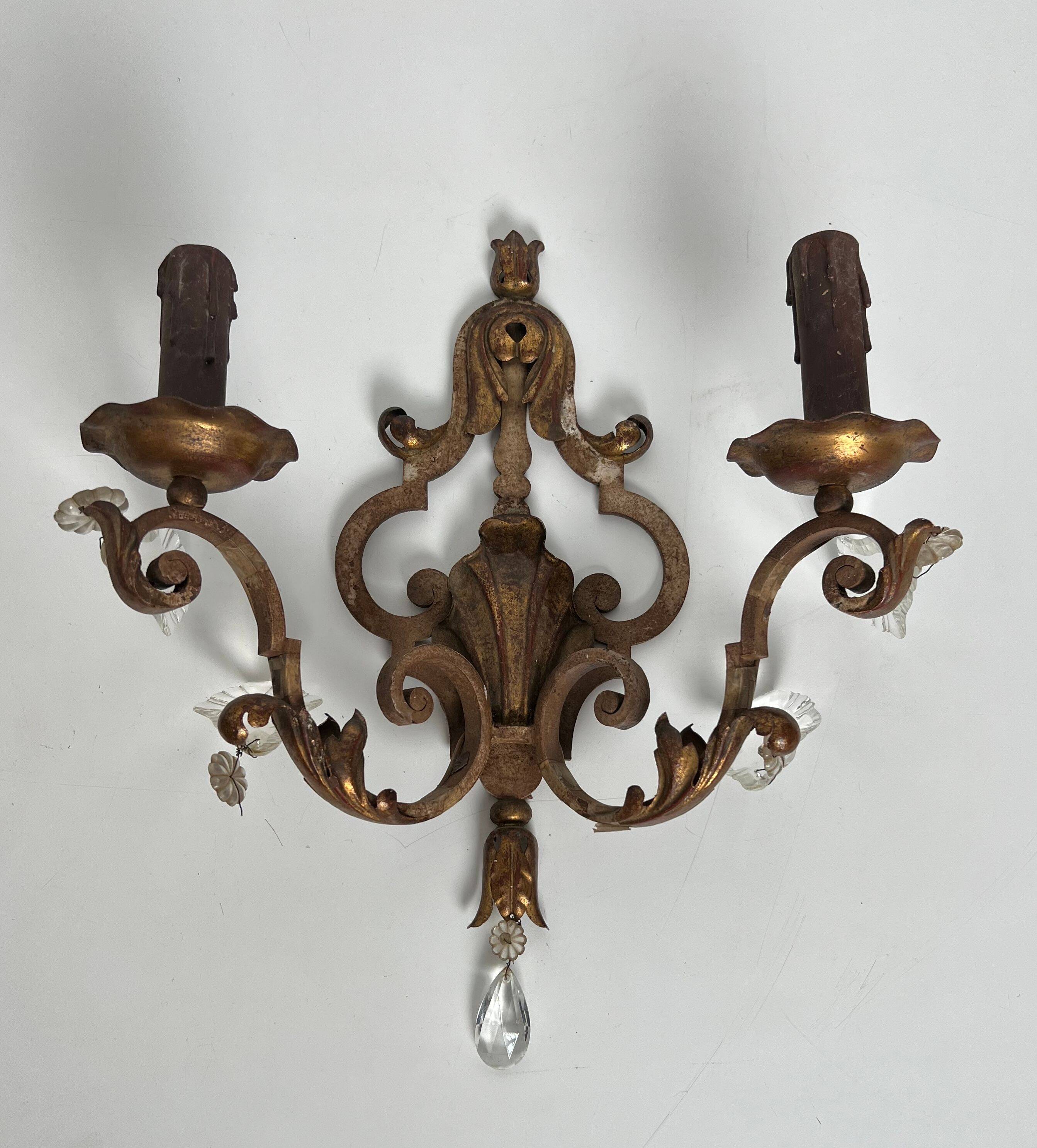 Pair of patinated wrought iron wall sconces with golden acanthus leaves and crystals.
