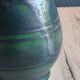 Vintage ceramic pitcher vase in glazed green and blue.
