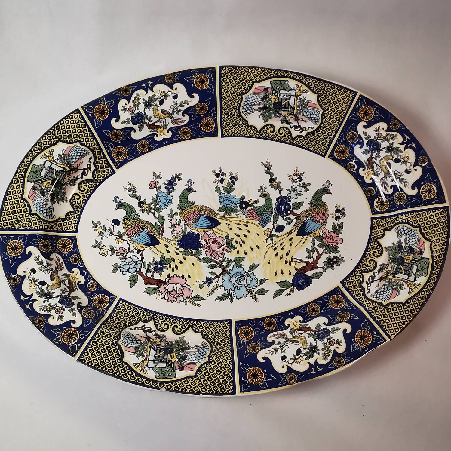 Ceramic dish decorated with peacock folk art Asian motif