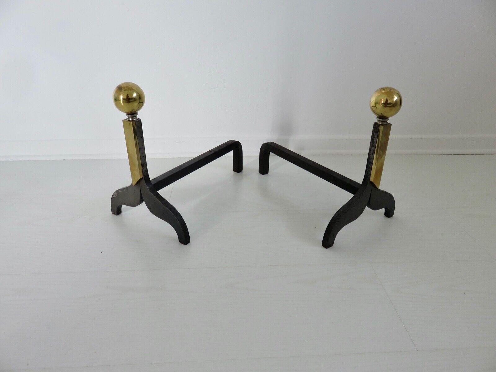 Pair of modernist steel and brass andirons