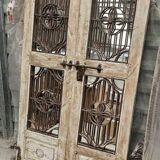 Chiseled teak door with openwork wrought iron panels