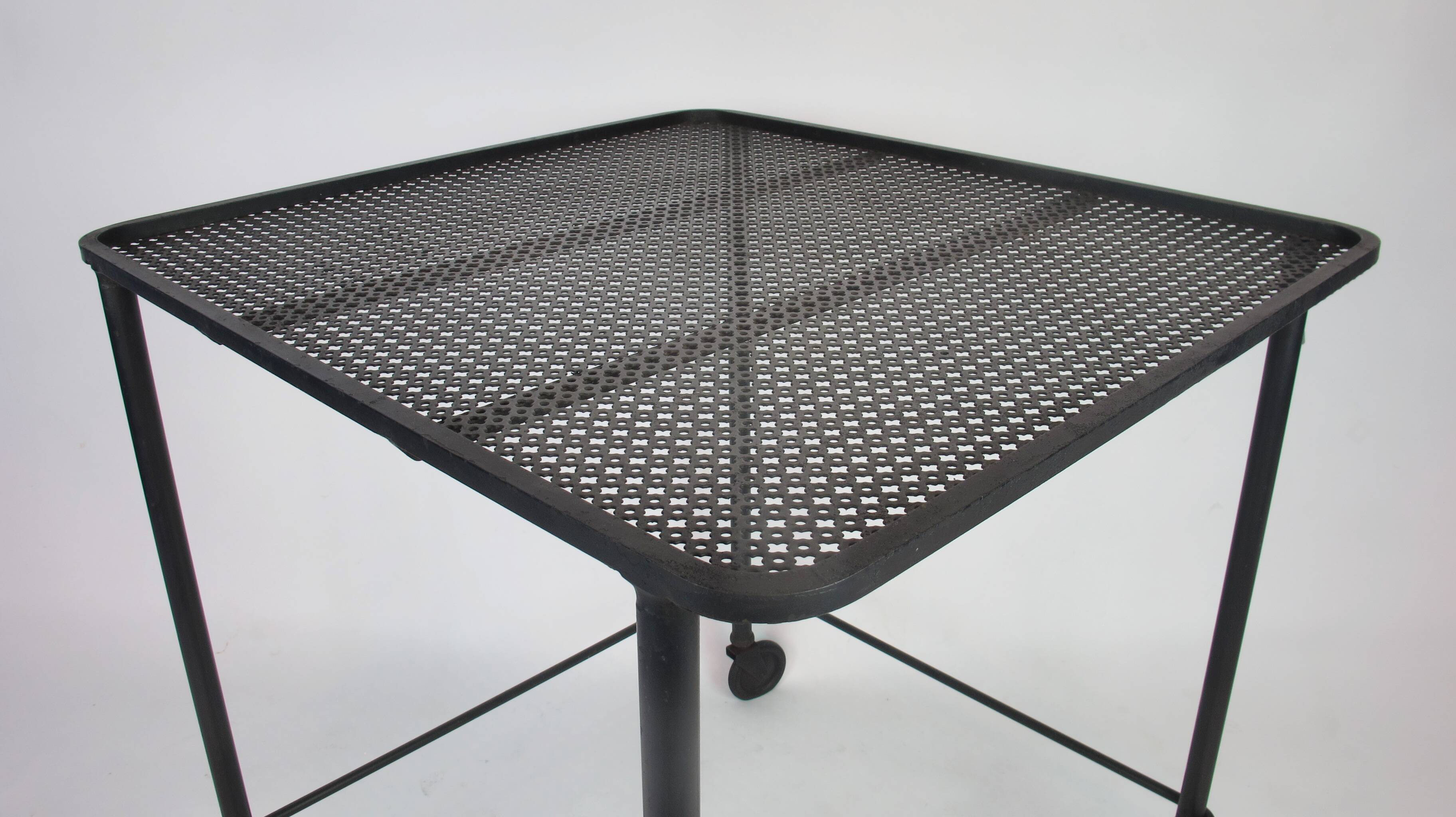 Mathieu Mategot's black wheelie table, 1950
