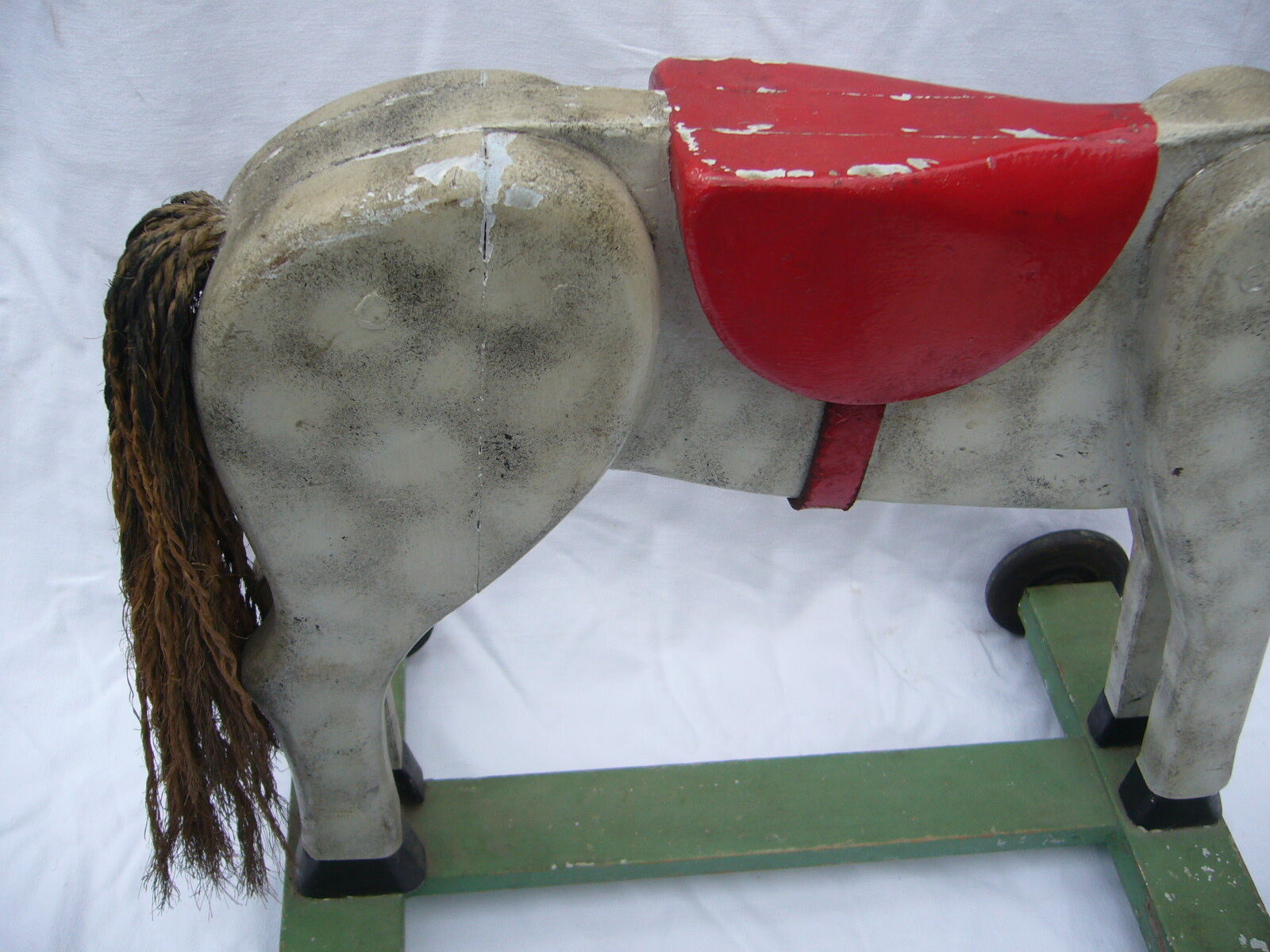 old wooden horse has wheels