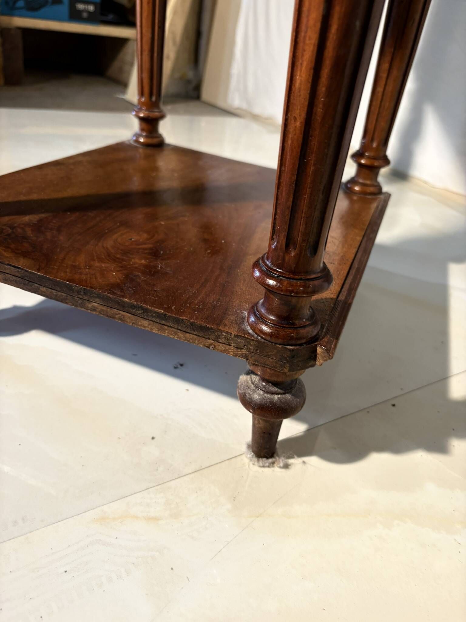 Antique wooden bedside table with turned legs.