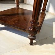 Antique wooden bedside table with turned legs.