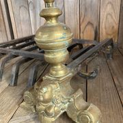 Pair of andirons and grates in cast iron and bronze with gilded grotesques, 17th century