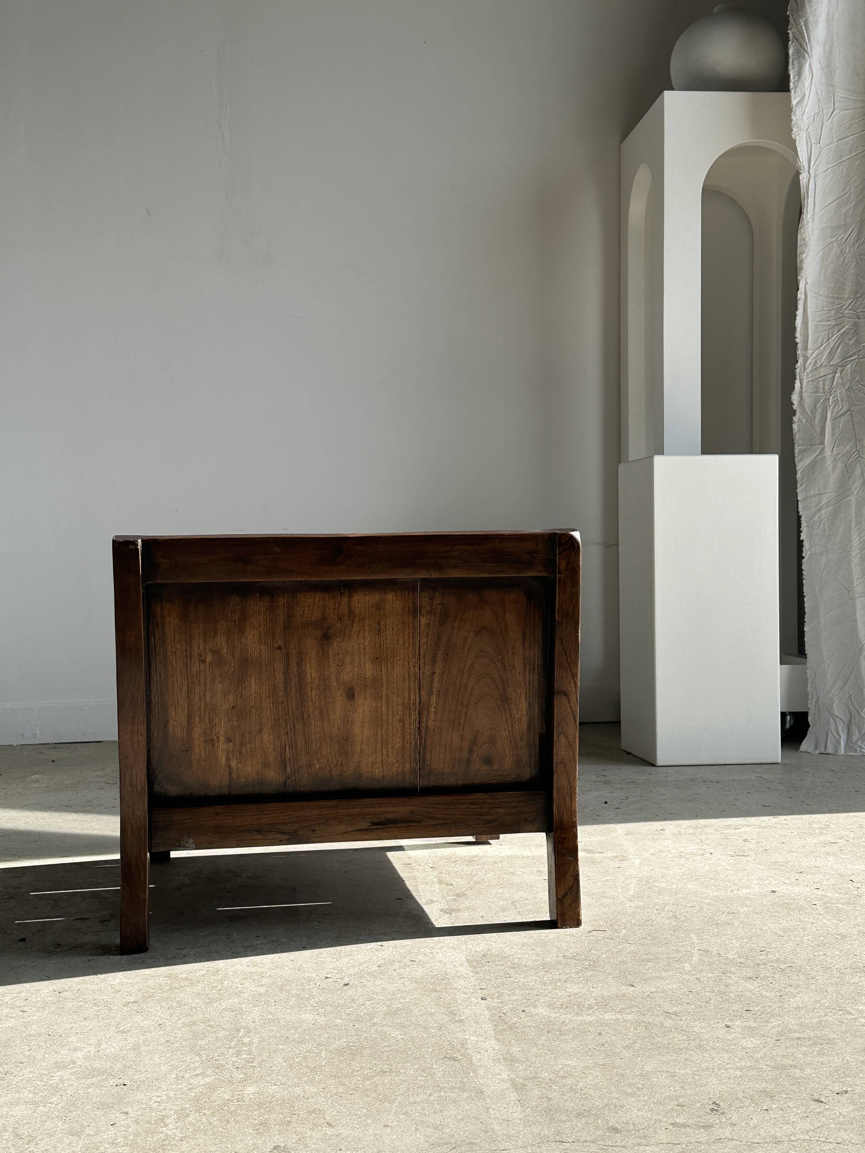 Small low armchair in varnished brown wood