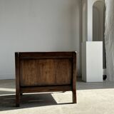 Small low armchair in varnished brown wood