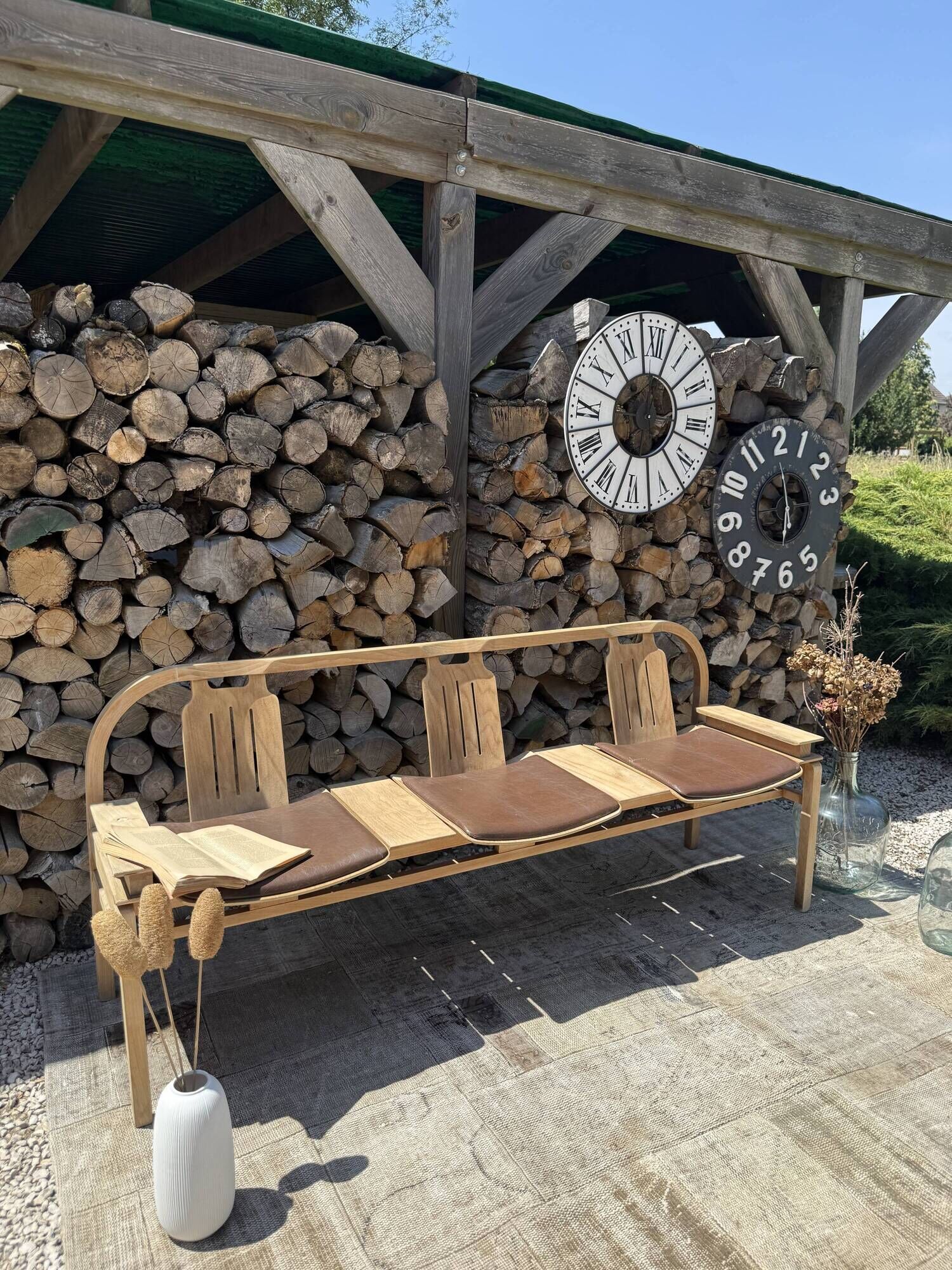 Baumann bench with wooden frame and faux leather seat.
