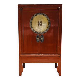 Antique red cabinet with brass details