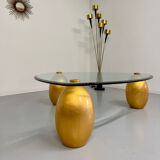 Vintage Italian design coffee table with a glass top and gold base, dating from the 1980s.