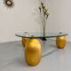 Vintage Italian design coffee table with a glass top and gold base, dating from the 1980s.