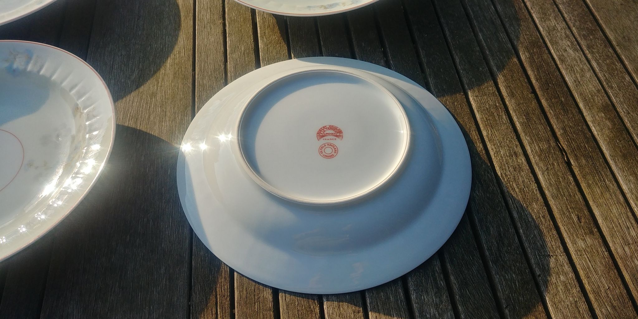 Set of four hollow Limoges porcelain plates signed Robert Haviland & Le Tanneur