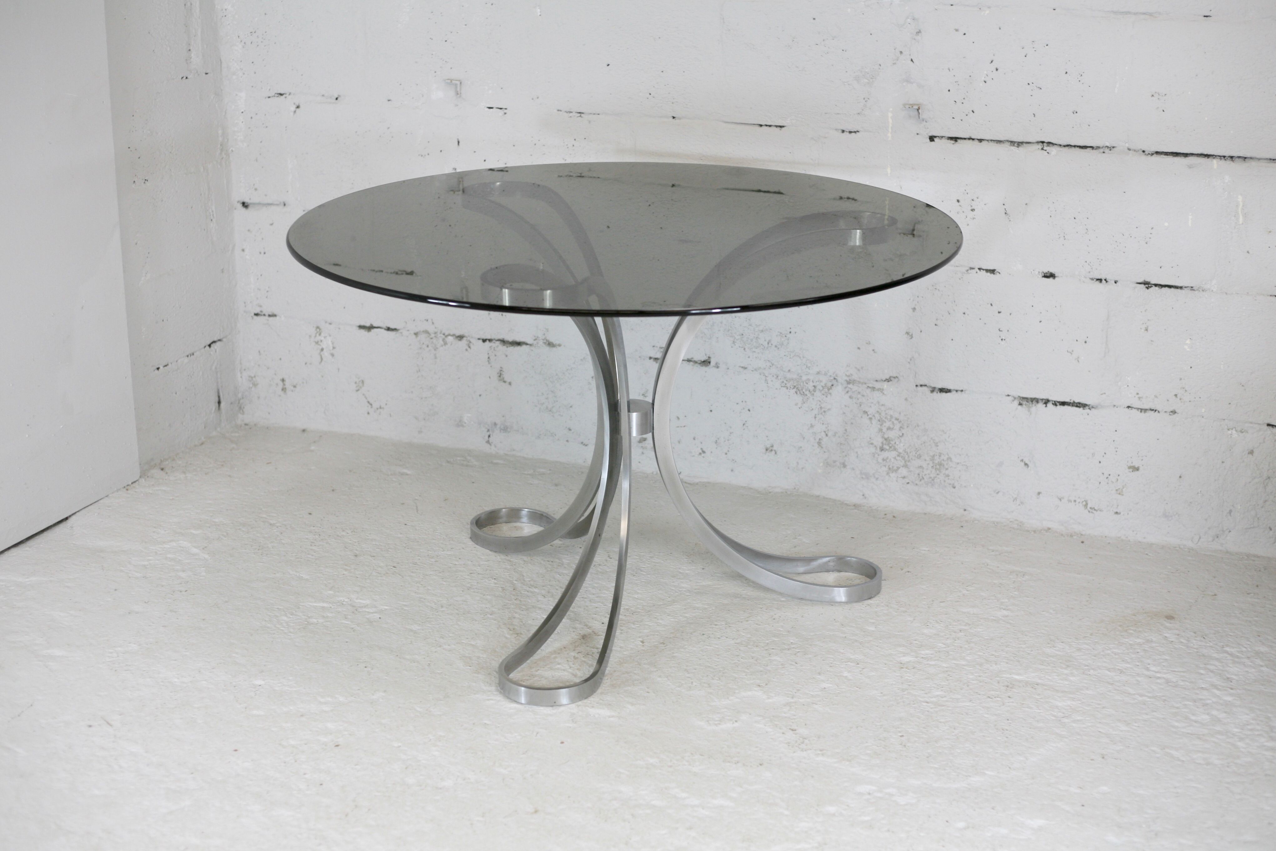 Living room table "Space Age" polished steel, circular slab smoked glass. France, circa 1970.