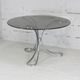 Table de séjour "Space Age" acier poli, dalle circulaire verre fumé. France, circa 1970.
