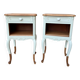 Renovated bedside tables in laurel green and light wood.