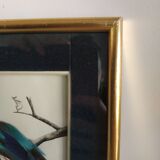 Framing a blue bird in feathers and painting