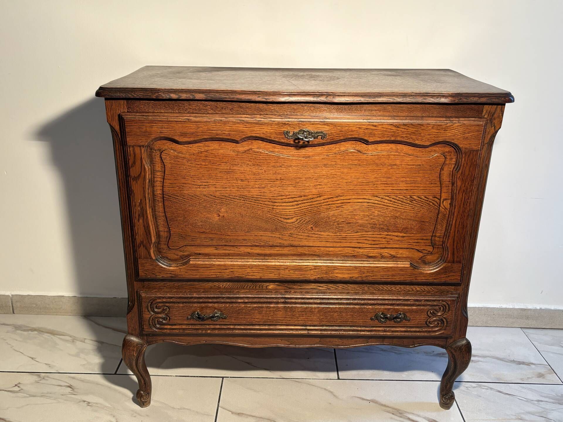 Louis XV style oak TV cabinet with drop-down flap.