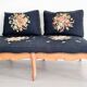 Old bench upholstered in black canvas flowers
