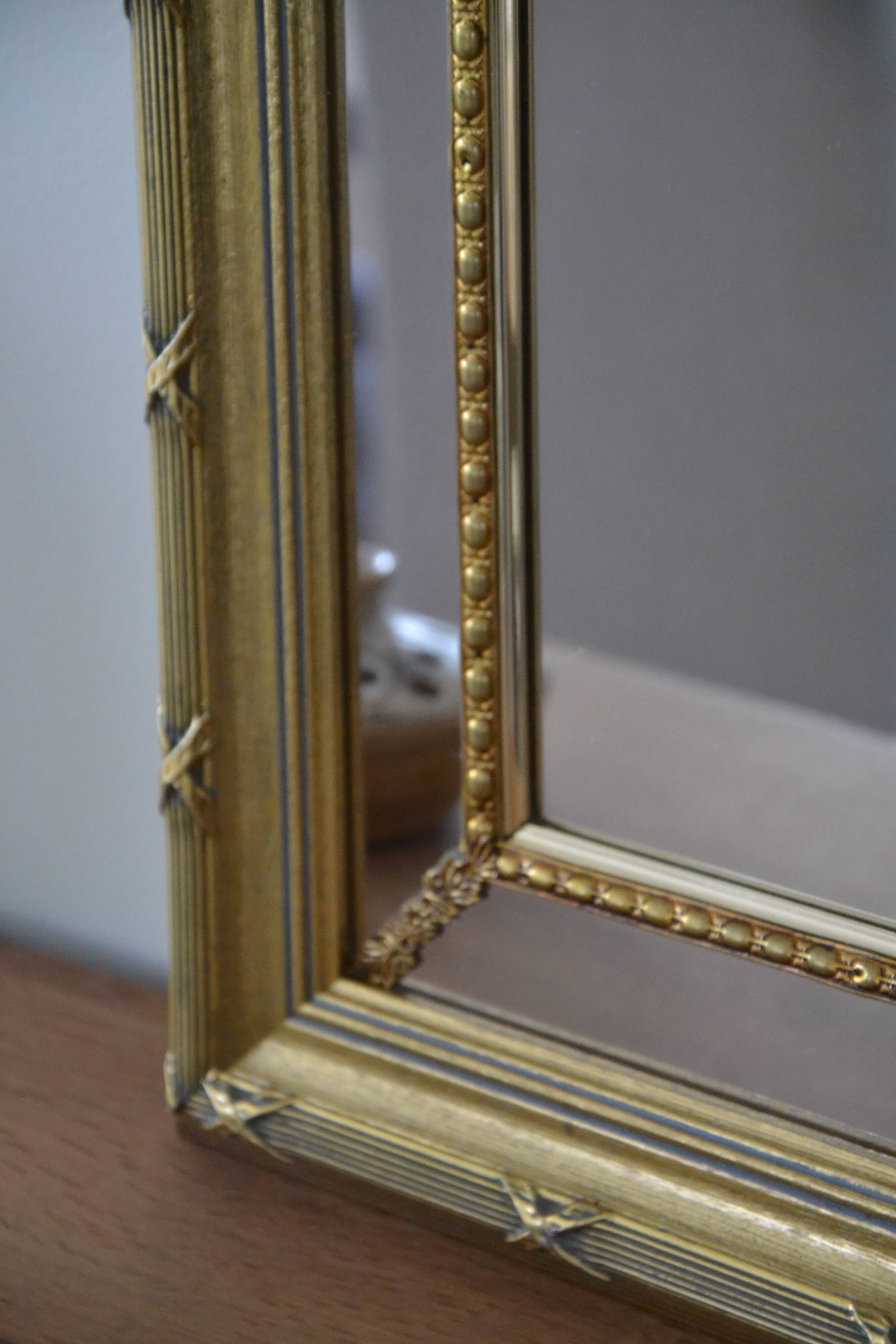 Large mirror with wooden gilded and carved frame.