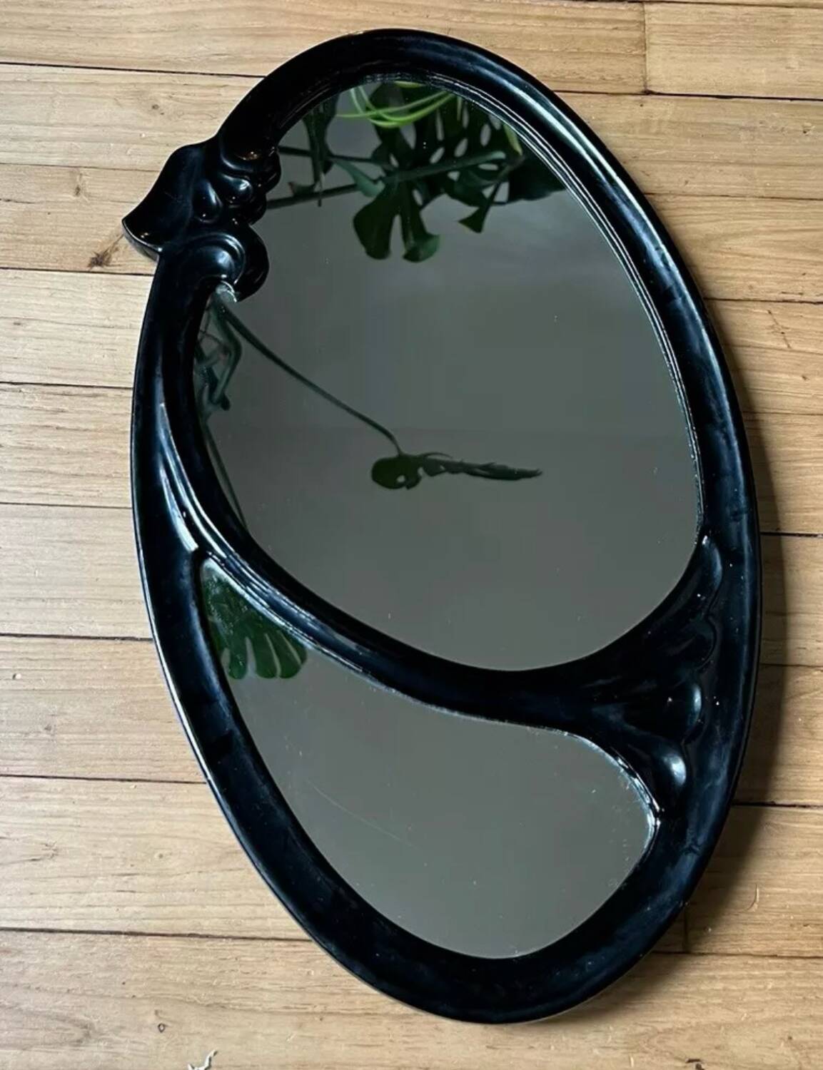Oval cast steel mirror with Art Nouveau decor
