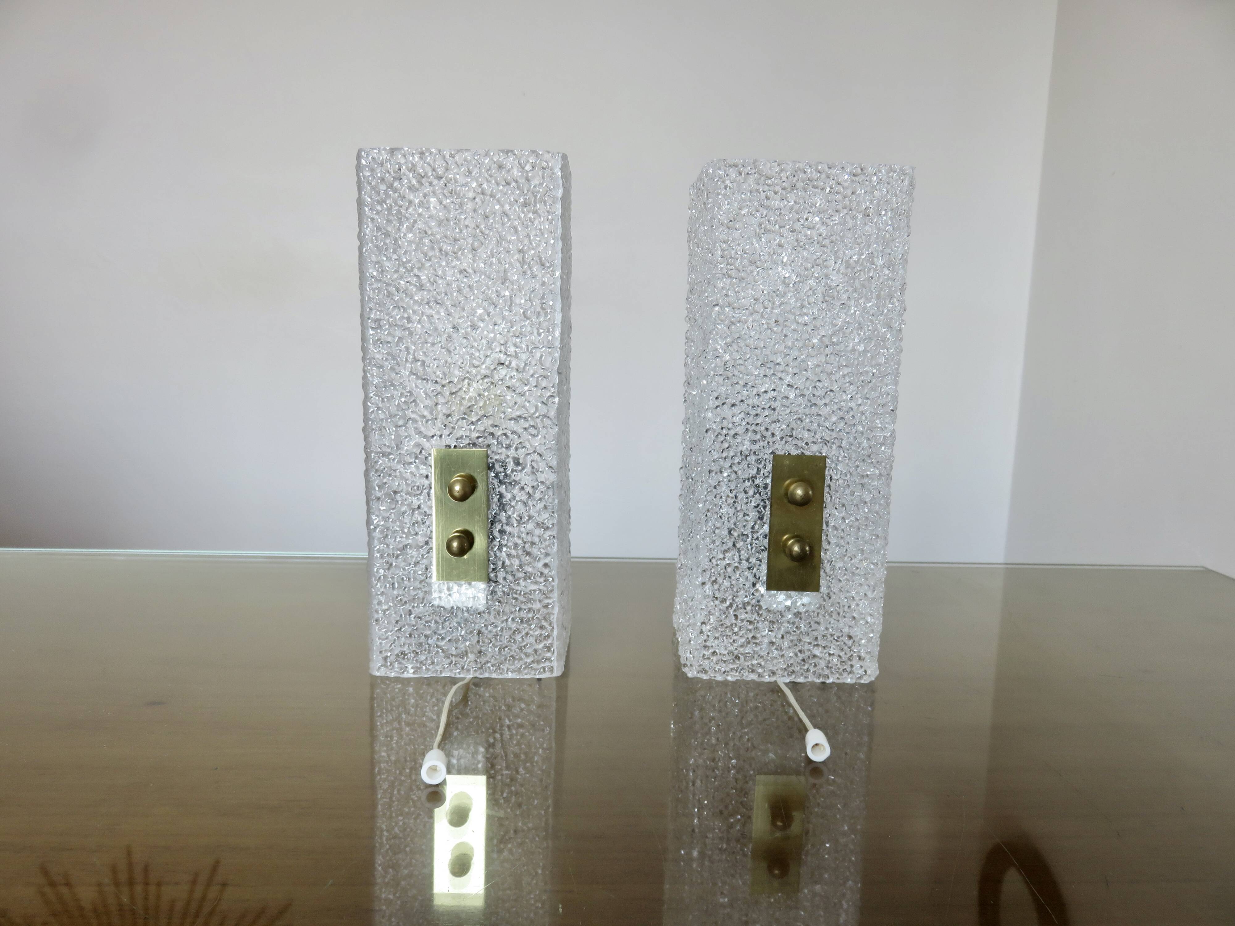 Pair of pull switch wall lights in perspex and gilded brass, France, circa 1960.