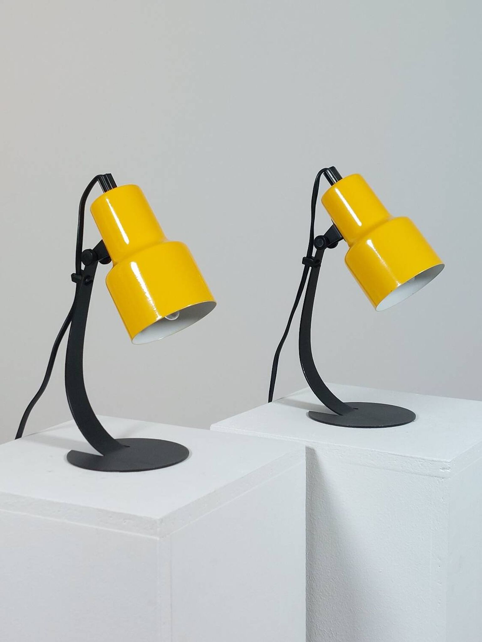 A pair of well-designed minimalist bedside lamps.