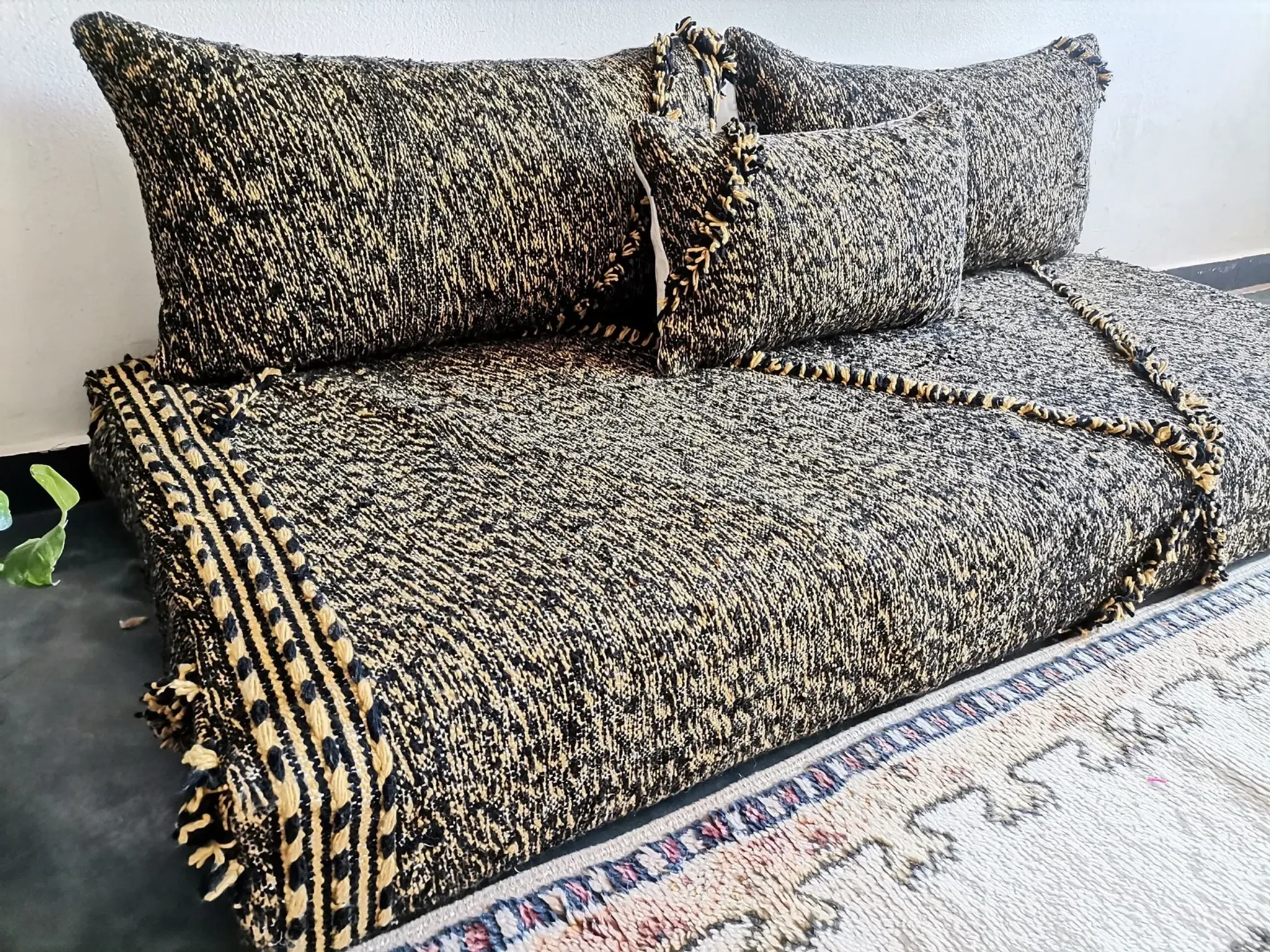 Moroccan sofa on the floor – black and gold pattern