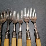 Old silver fish forks with bone handles