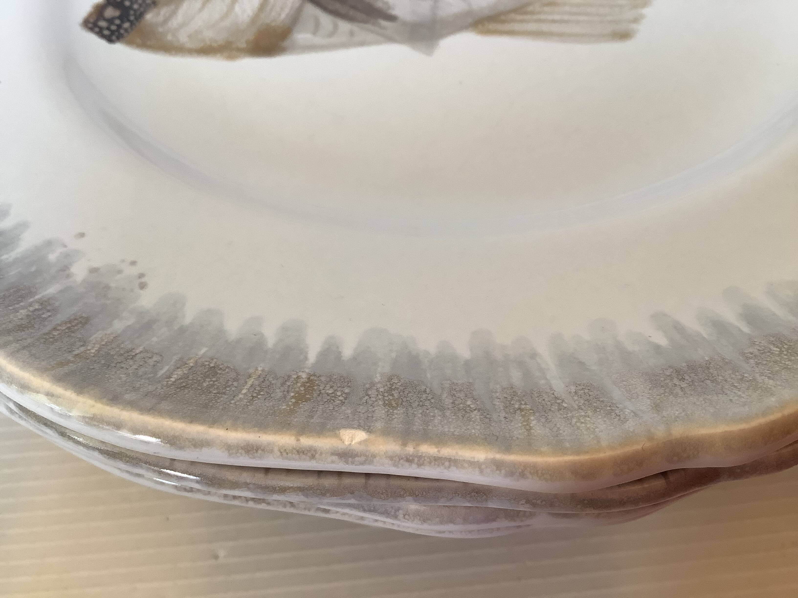 Six hand-decorated fish plates.