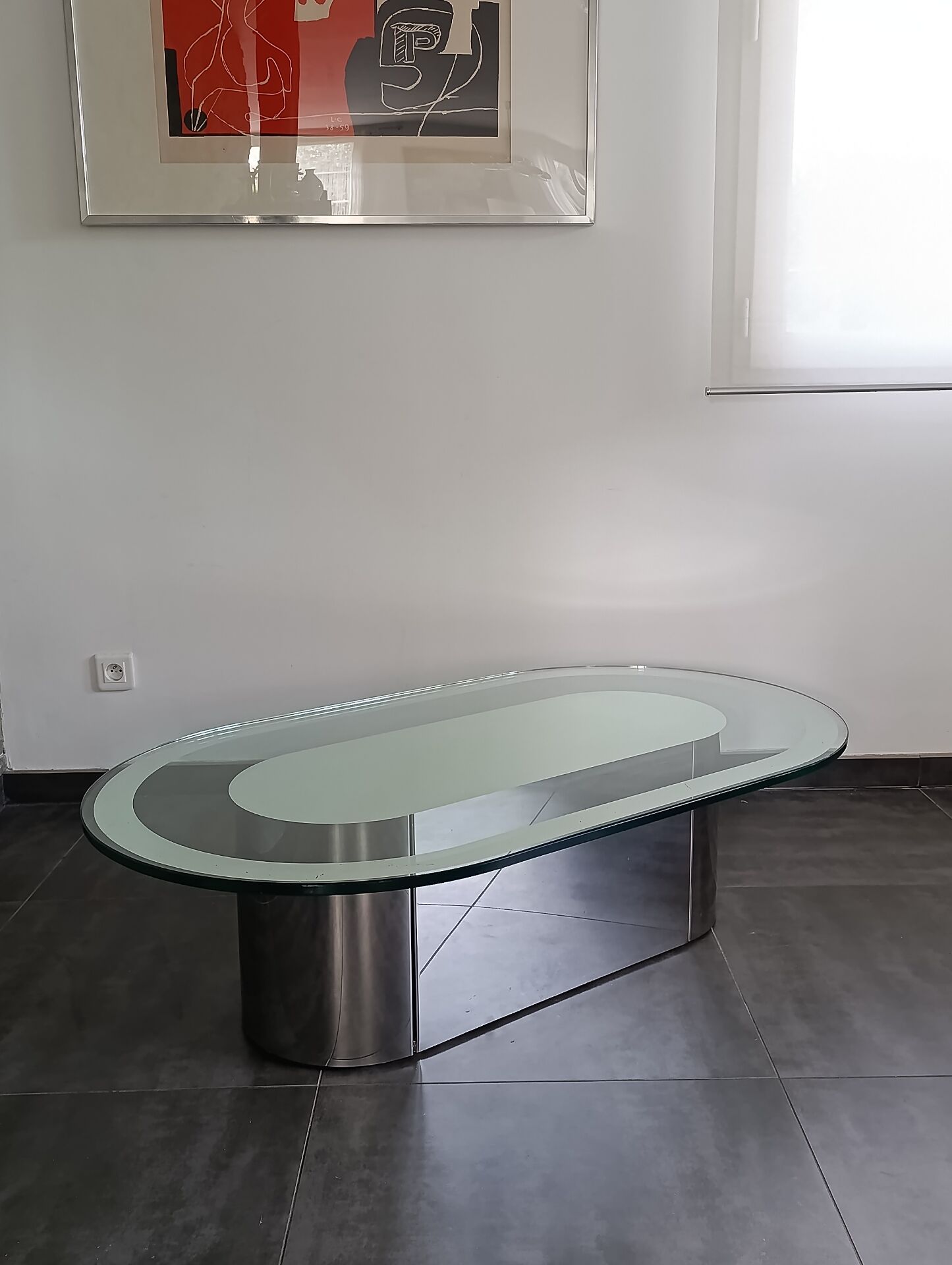 Vintage coffee table with glass and chrome metal.