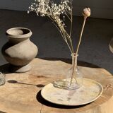 Petrified wood catchall or dish in beige with several grey spots in the centre.